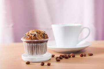 Cup cake  and coffee cup on wooden desk,soft focus.