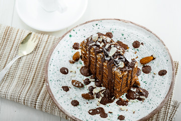 Delicious sweet chocolate Spartak cake on a rustic plate. Haute cuisine dessert. International food. Top view.