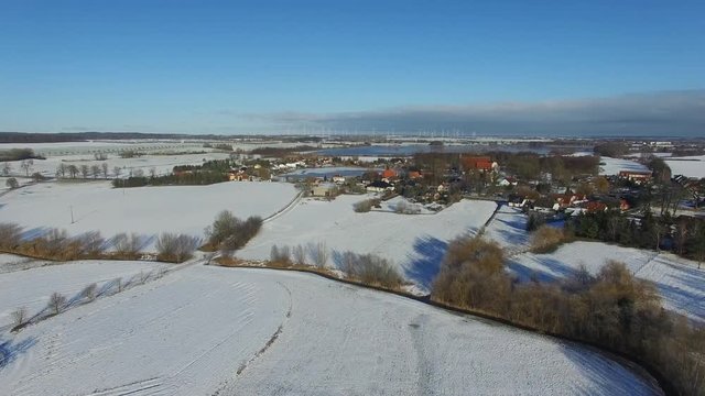 aerial view fly over snowy landscape with blue sky in germany - dronen flight
