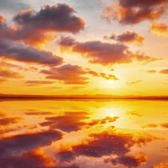 Beautiful cloudy sky above salt water lake. Scenic sunset landscape.