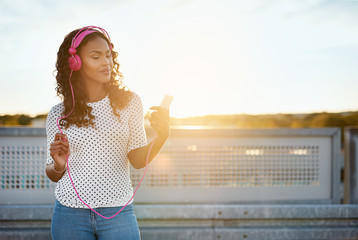 Pretty black girl in pink headphones
