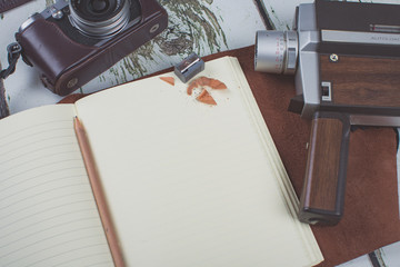 A Journal surrounded by camera equipment