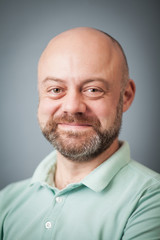 Portrait of a bearded middle-aged man on gray background