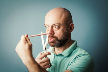 Worried bearded middle-aged  man with long nose isolated on blue