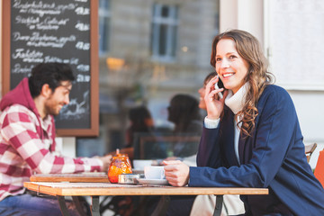 Woman talking on the phone at a cafe