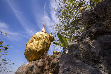 Amazing golden Buddhist pagoda on the cliff 