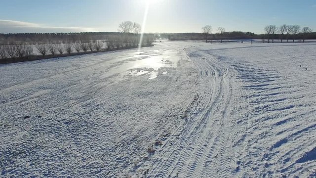 aerial view  fly over beautiful snowy landscape with sun and blue sky in germany - dronen flight