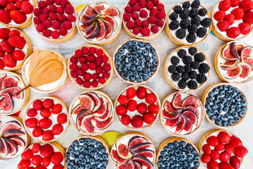 Fruit and Berry tarts dessert assorted top view background