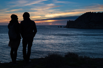 couple watching the sunset on the sea