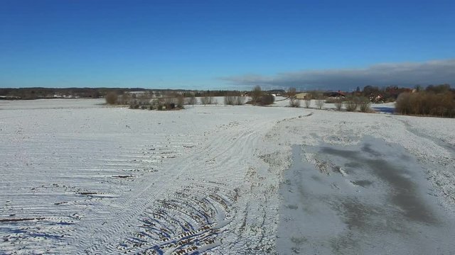 aerial view fly over snowy landscape with blue sky in germany - dronen flight