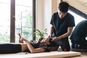 Therapist Giving acupuncture Treatment To a Japanese Woman - obrazy, fototapety, plakaty