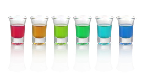 Six different color drinks in glasses on white background