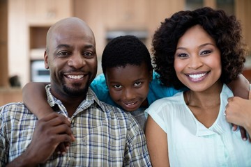 Portrait of mother, father and son in living room