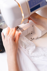 Seamstress makes stitch on sewing-machine