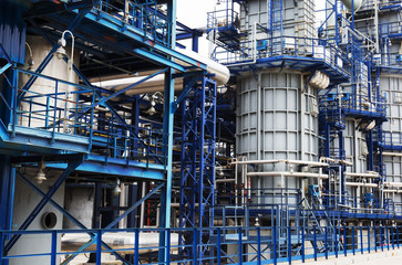 Close-up of pipelines and destillation tanks of an oil-refinery plant