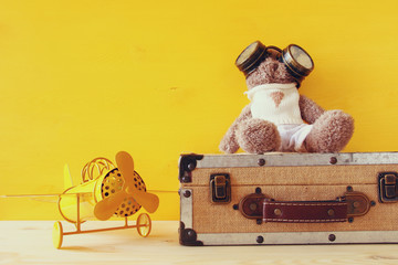 Photo of vintage toy plane and cute teddy bear