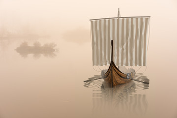 Viking ship on the water in the mystical fog.