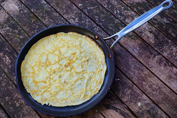 A French crepe just cooked in a flat pan