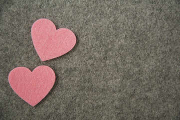 pink hearts on gray felt background. valentine's day