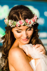 Beautiful bride in wedding dress and with a lovely mood in nature