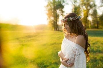 Fototapeta na wymiar Beautiful bride in wedding dress and with a lovely mood in nature