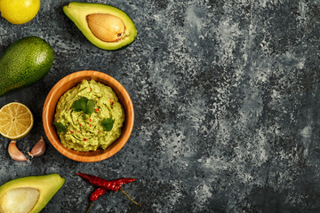 Homemade guacamole with ingredients.