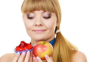 Woman choosing fruit or cake make dietary choice