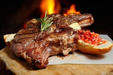 delicious piece of meat roasted on a background of fire