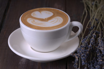 Coffee with a lavender on wooden table