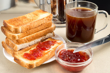 Hot toast with strawberry jam and coffee mug