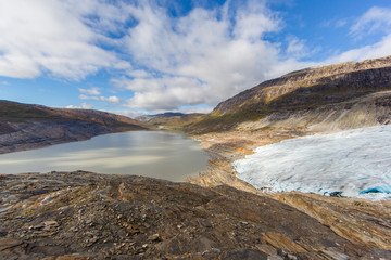 Ice front of Svartisen Glacier in Norway with lake