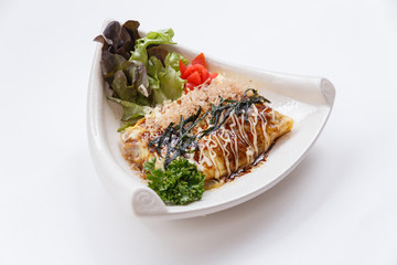Japanese Omelette with Okonomiyaki Sauce Topping with Katsuobushi (dried, fermented, and smoked skipjack tuna), Seaweed and Mayonaise.