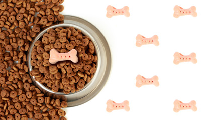 Dog bowl with pet feed on the half white background and scattered dry food
