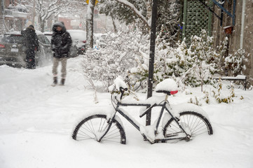 Bike covered with fresh snow in Montreal during snow storm (December 2016)