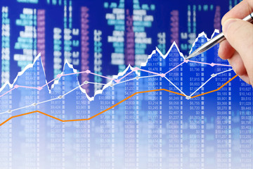 Businessman analyzing financial chart on virtual screen