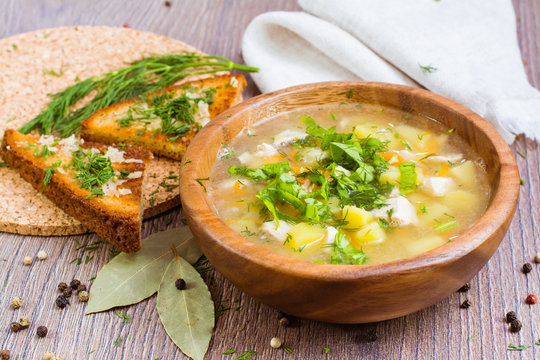 Гороховый суп в деревянной тарелке и чесночные гренки