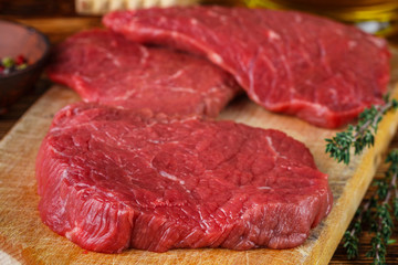 Fresh meat. Raw beef chops on a cutting Board ready to prepare a delicious dinner. Selective focus
