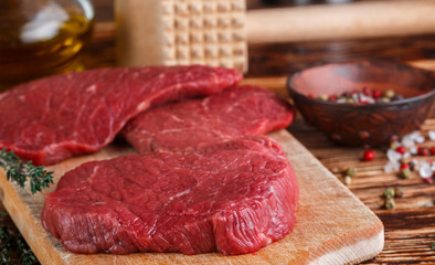 Fresh meat. Raw beef chops on a cutting Board ready to prepare a delicious dinner. Selective focus
