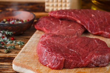 Fresh meat. Raw beef chops on a cutting Board ready to prepare a delicious dinner. Selective focus
