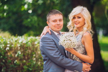 Fototapeta premium Beautiful young couple posing on wedding ceremony