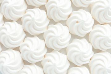Closeup of mini meringues on white as food background. - obrazy, fototapety, plakaty