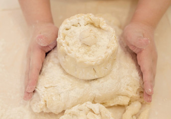 Mother and daughter hands preparing the dough