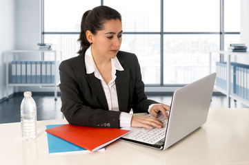 businesswoman  wearing a business suit working on laptop computer at modern office room