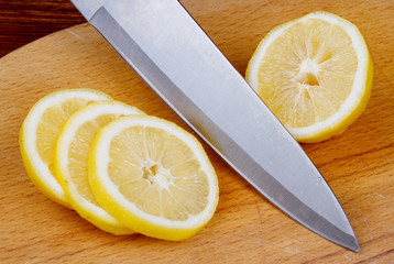 lemon cut into slices on a cutting board