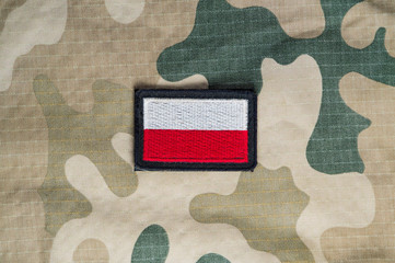Polish flag on a military uniform in desert camouflage