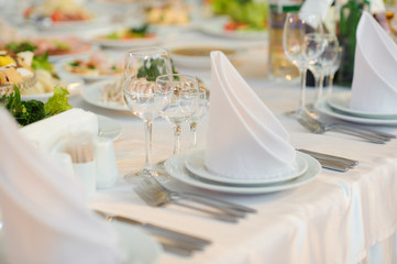 table set service with silverware and glass stemware at restaurant before party
