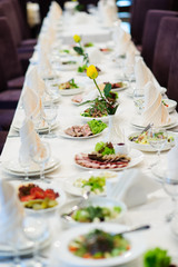 table set service with silverware and glass stemware at restaurant before party