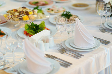 table set service with silverware and glass stemware at restaurant before party