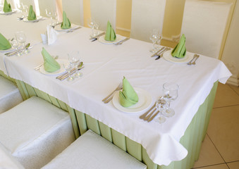 table set service with silverware and glass stemware at restaurant before party