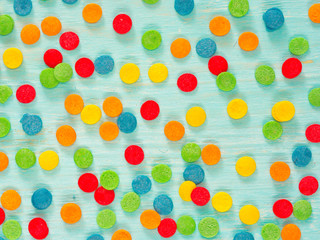 Border frame of colorful sprinkles on blue background